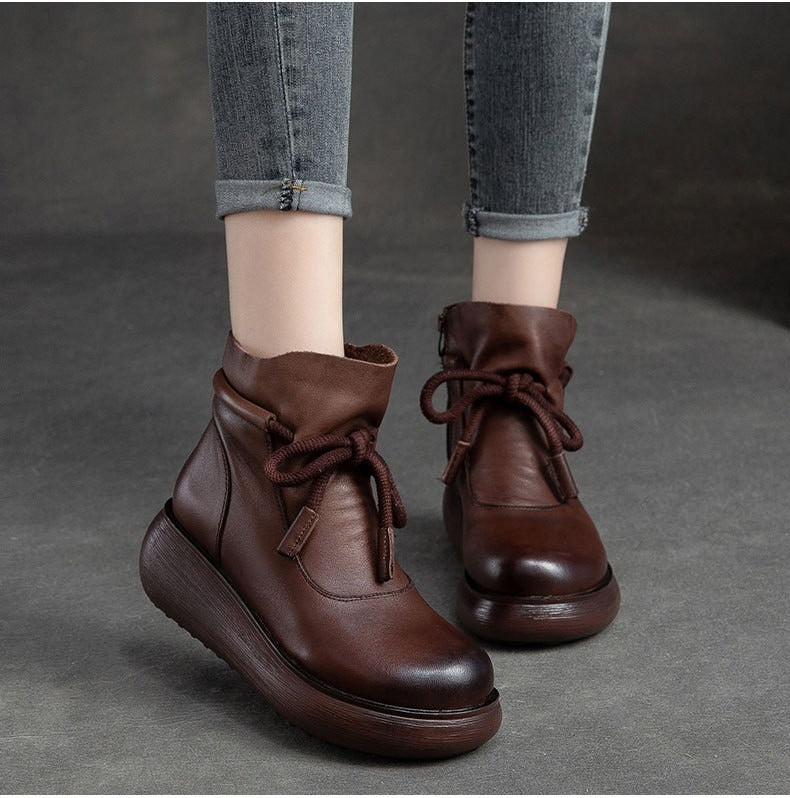 Brown leather lace-up wedge boots, shown on foot