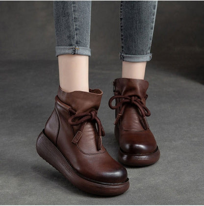 Brown leather lace-up wedge boots, shown on foot