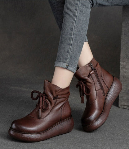 Brown leather lace-up wedge boots, shown on foot